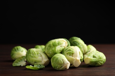 Fresh Brussels sprouts on brown wooden table, closeup