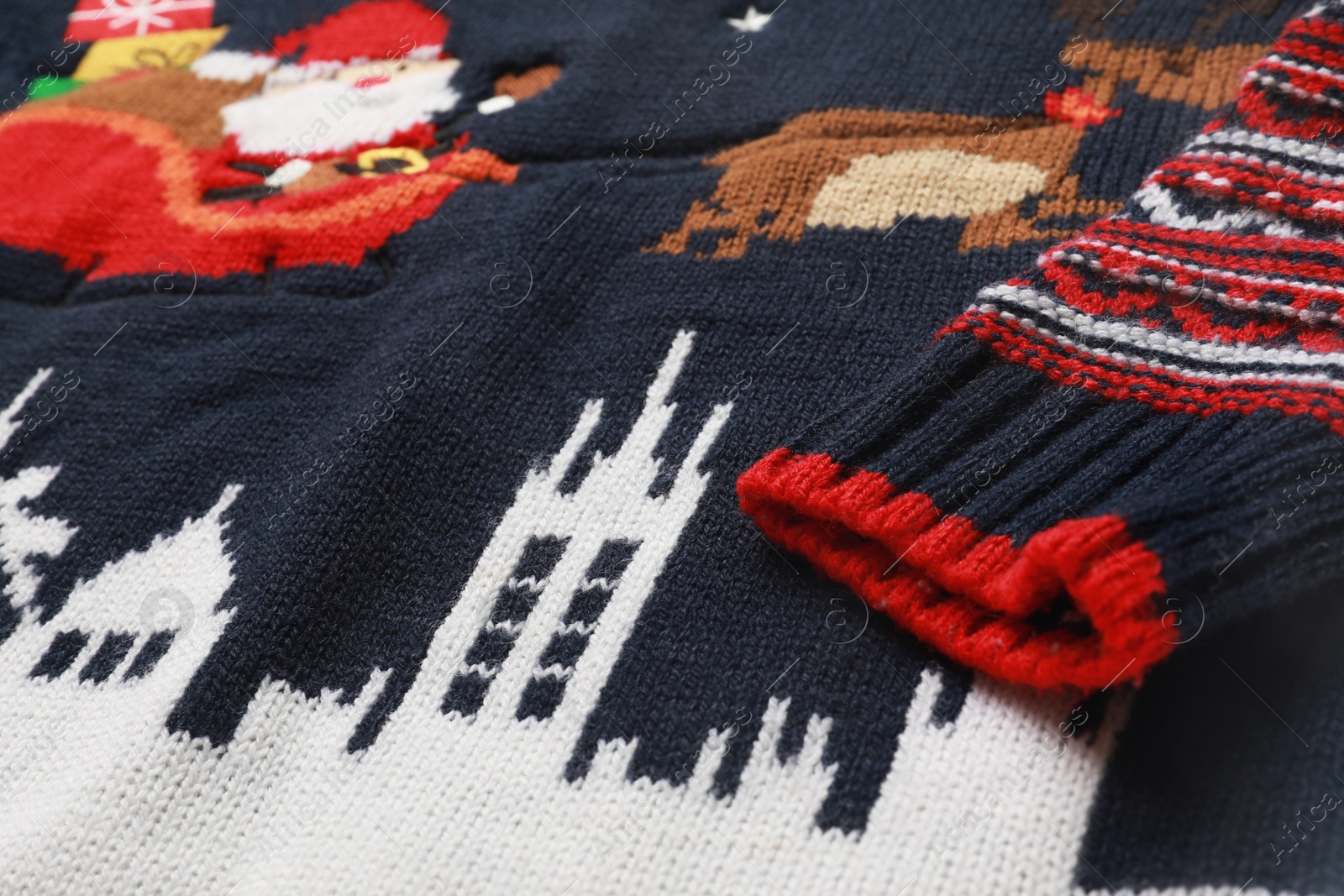 Photo of Cute Christmas sweater as background, closeup view