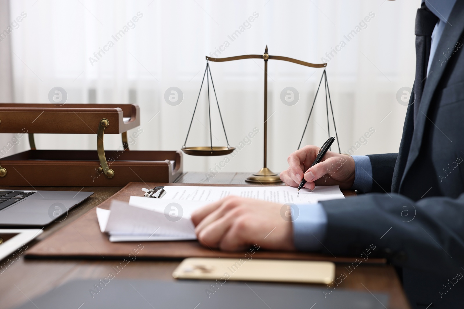 Photo of Lawyer working with documents at table indoors, closeup