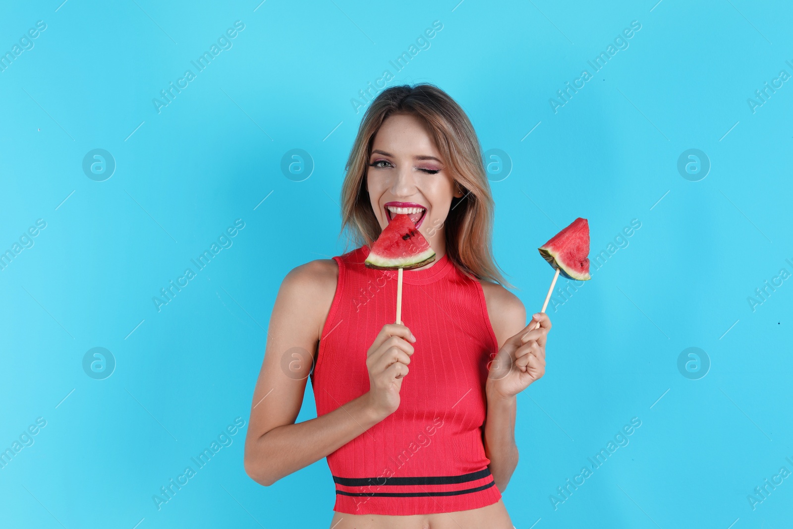 Photo of Pretty young woman with juicy watermelon on color background