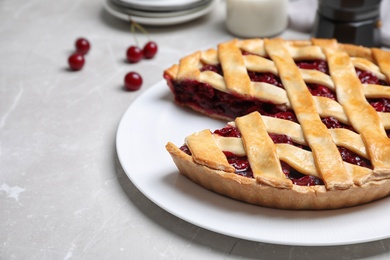 Delicious fresh cherry pie on light grey marble table