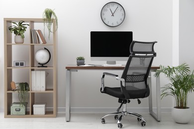 Photo of Workspace with desk, chair and computer at home