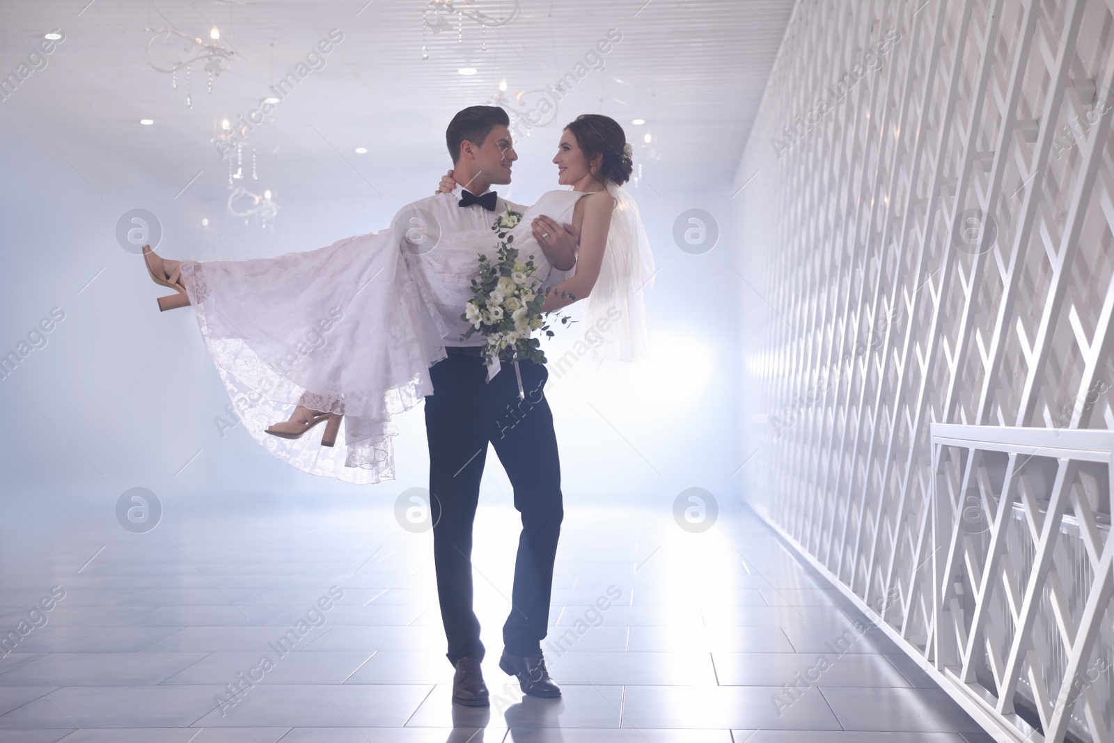 Photo of Happy newlywed couple dancing together in festive hall