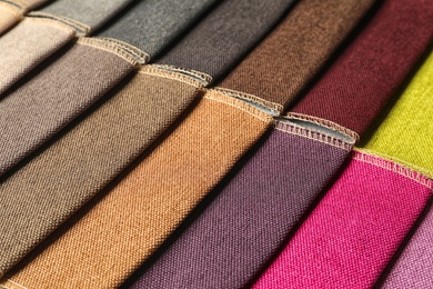 Photo of Fabric samples of different colors for interior design as background