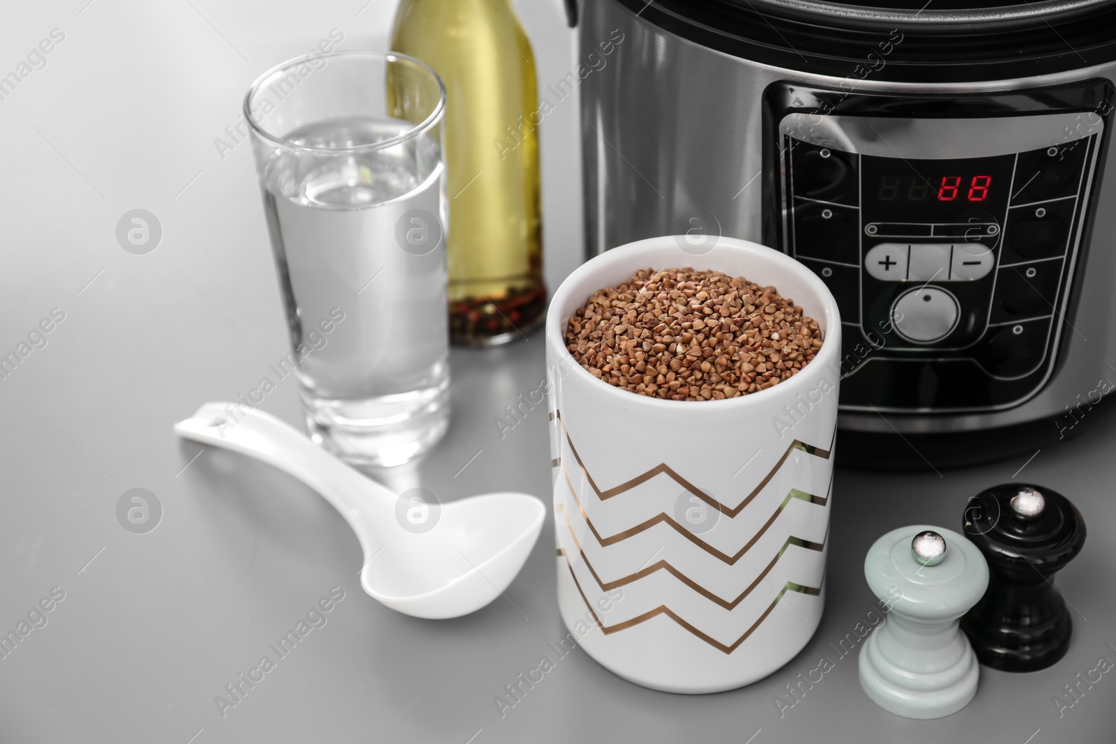 Photo of Modern multi cooker and ingredients on table, space for text