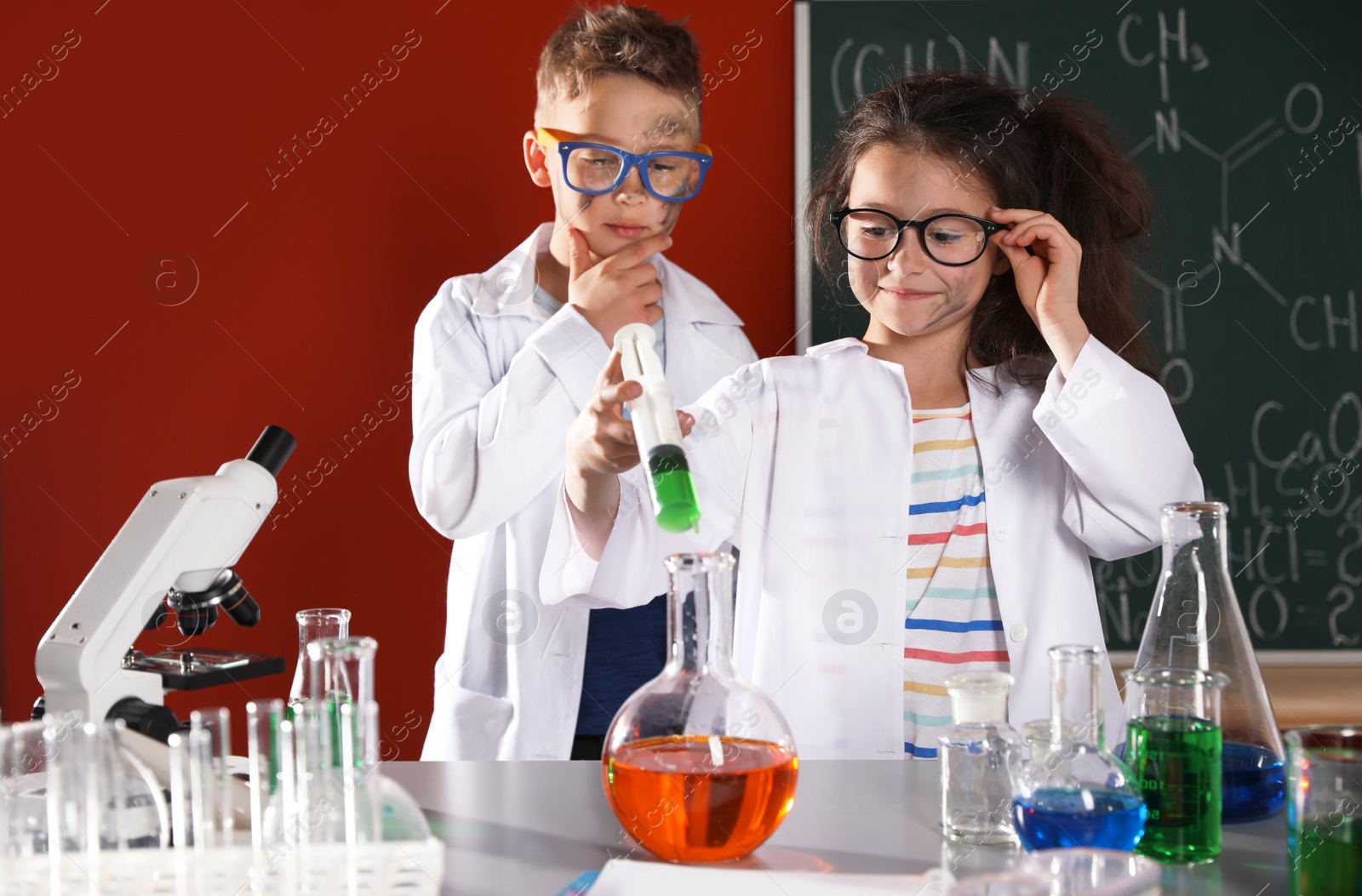 Photo of Children doing chemical research in laboratory. Dangerous experiment