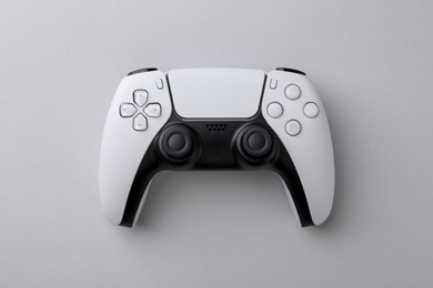 Wireless game controller on light grey background, top view