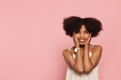 Photo of Portrait of smiling African American woman on pink background. Space for text
