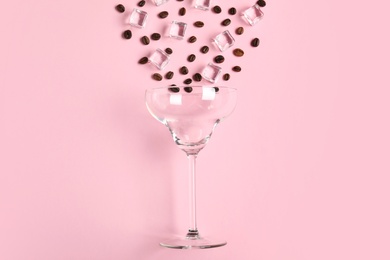 Photo of Flat lay composition with glass, coffee beans and ice cubes on color background. Alcohol cocktail recipe - Espresso Martini