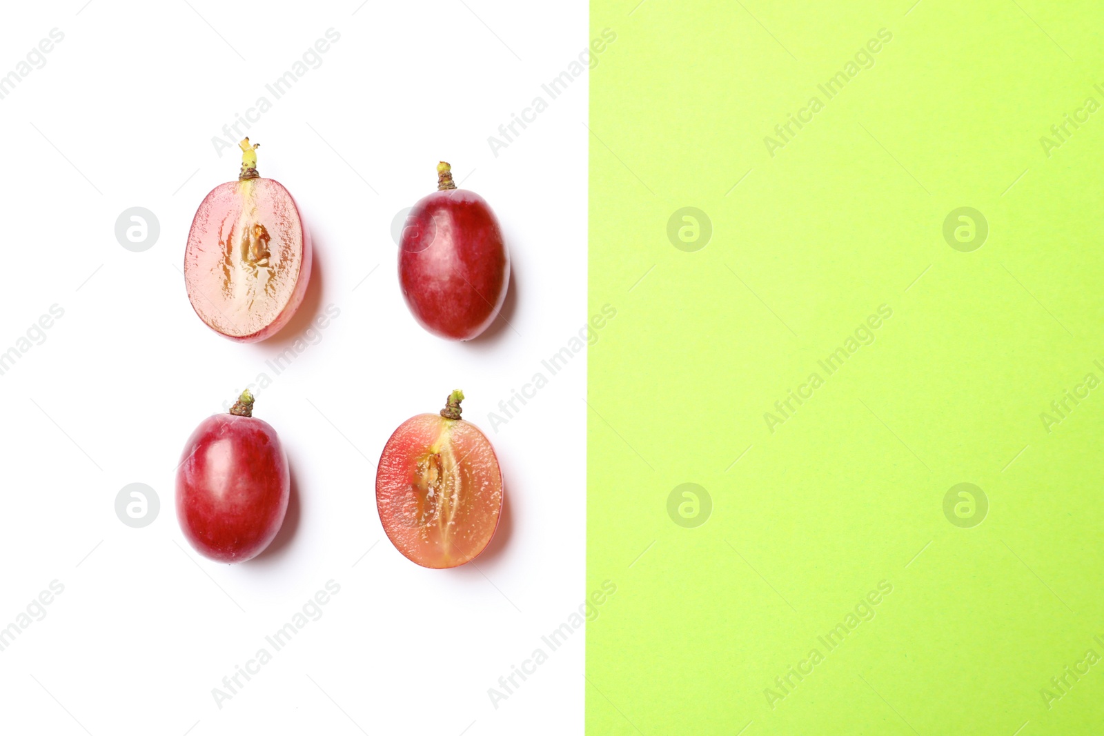 Photo of Fresh ripe juicy grapes on color background, top view. Space for text