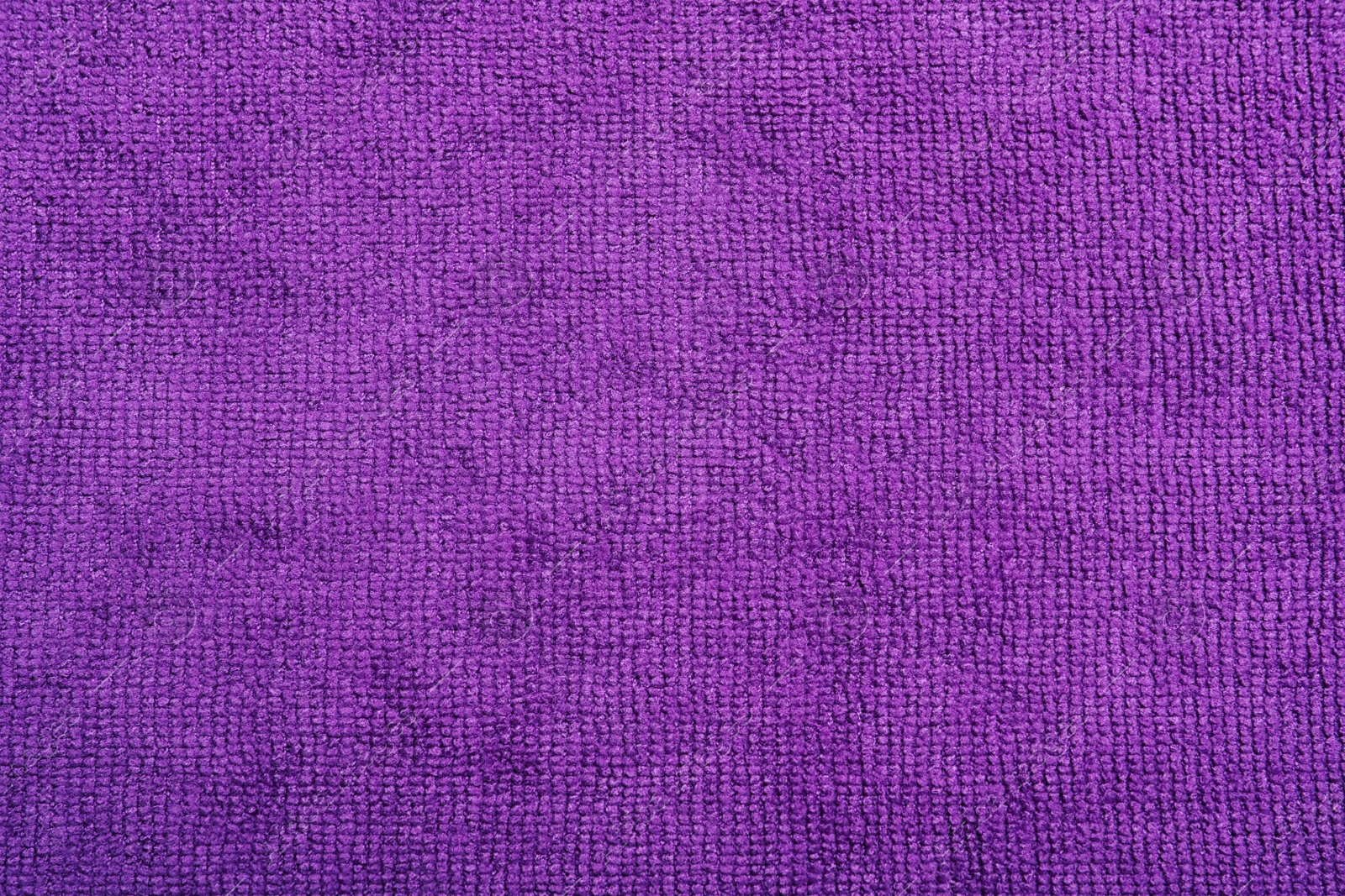 Photo of Purple microfiber cloth as background, top view