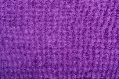 Purple microfiber cloth as background, top view