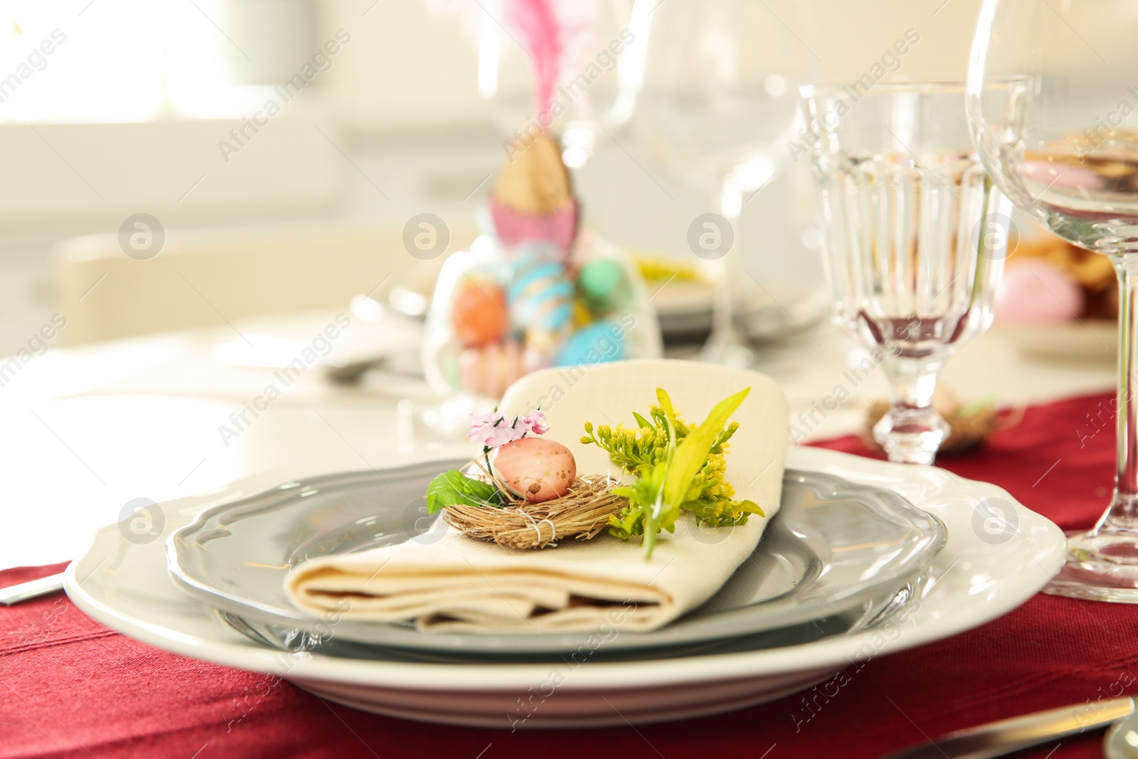 Photo of Festive Easter table setting with floral decor, closeup