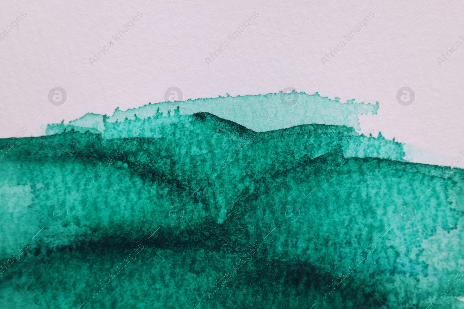 Photo of Abstract green watercolor painting on white paper, top view