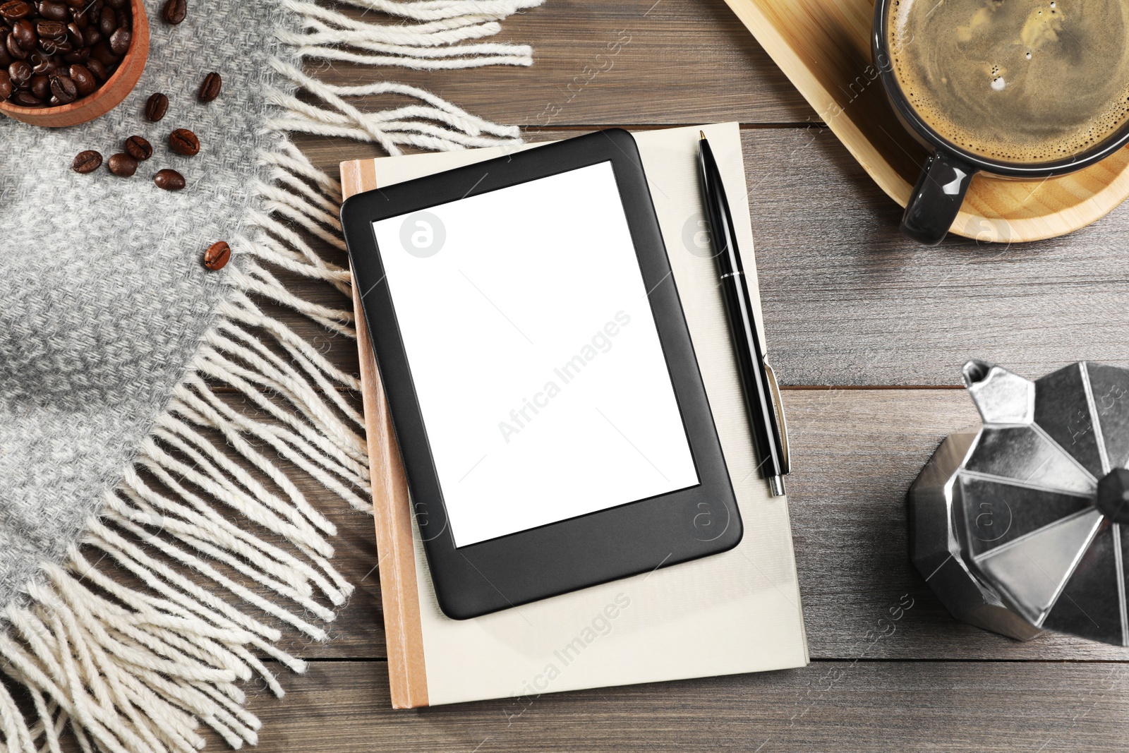 Photo of E-book reader with notebook and coffee on wooden table, flat lay. Space for text