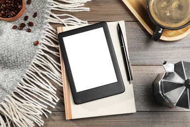 Photo of E-book reader with notebook and coffee on wooden table, flat lay. Space for text