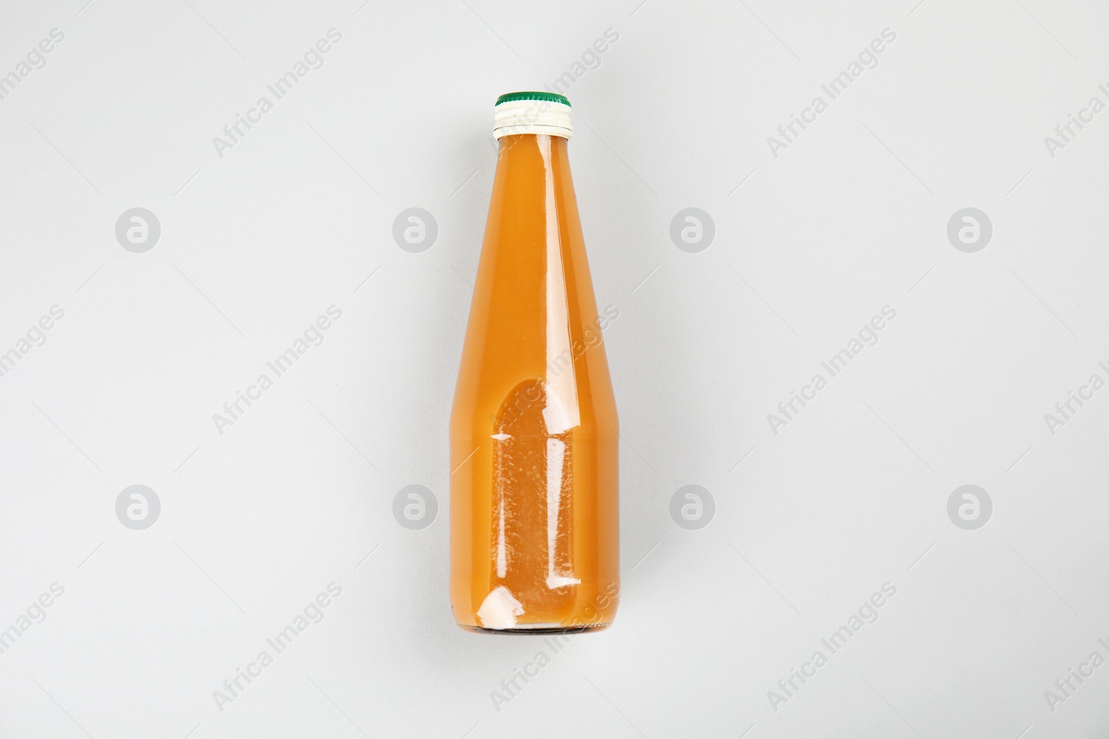 Photo of One bottle with tasty drink on color background, top view