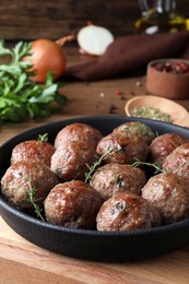 Tasty cooked meatballs served on wooden board