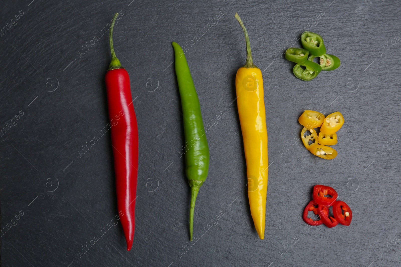 Photo of Flat lay composition with chili peppers on grey background