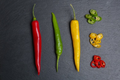 Photo of Flat lay composition with chili peppers on grey background