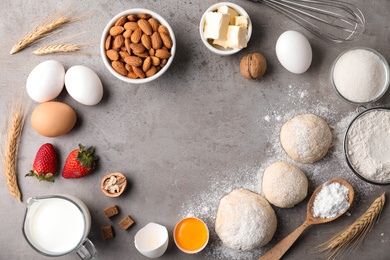 Flat lay composition with dough on grey table, space for text. Cooking pastries