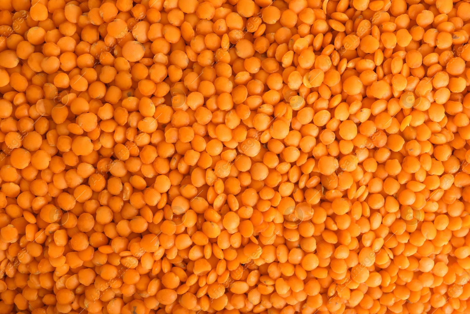 Photo of Organic red lentils as background, top view