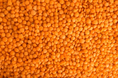 Organic red lentils as background, top view