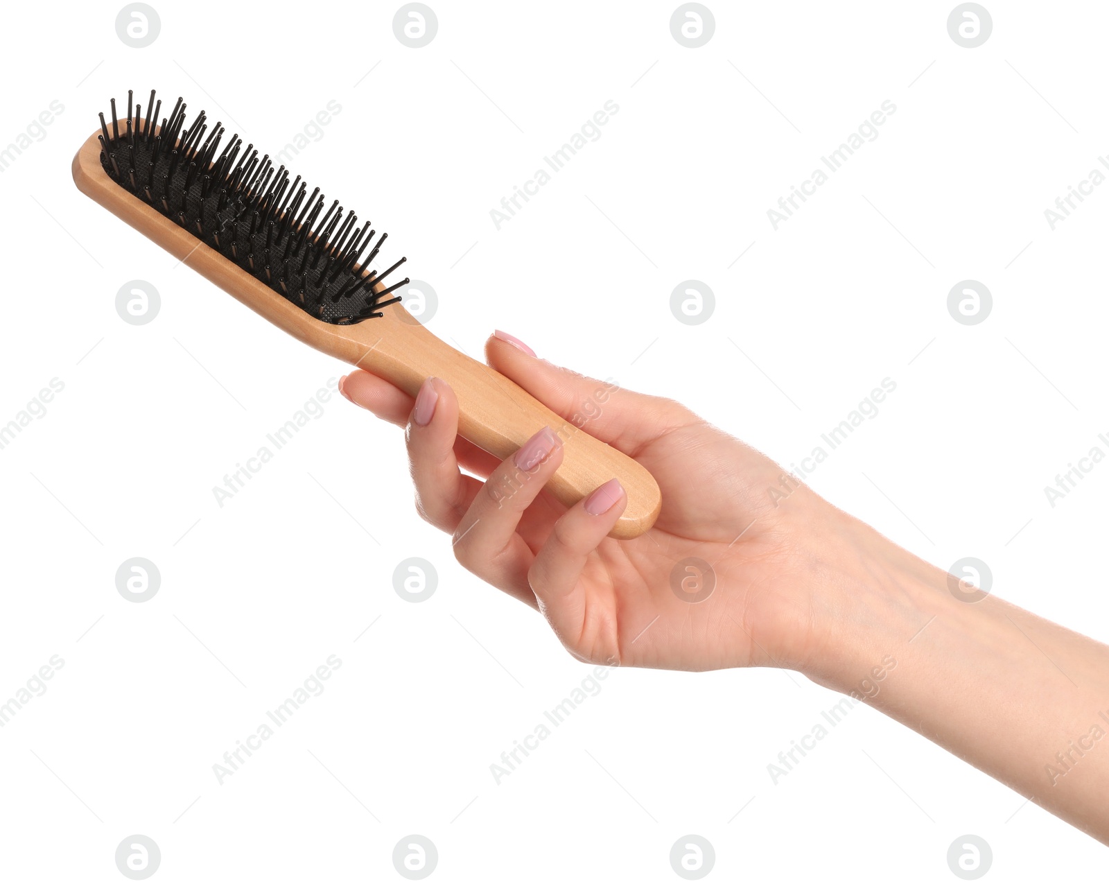 Photo of Woman holding wooden hair brush against white background, closeup