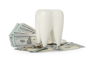 Photo of Ceramic model of tooth, dollar banknotes and coins on white background. Expensive treatment