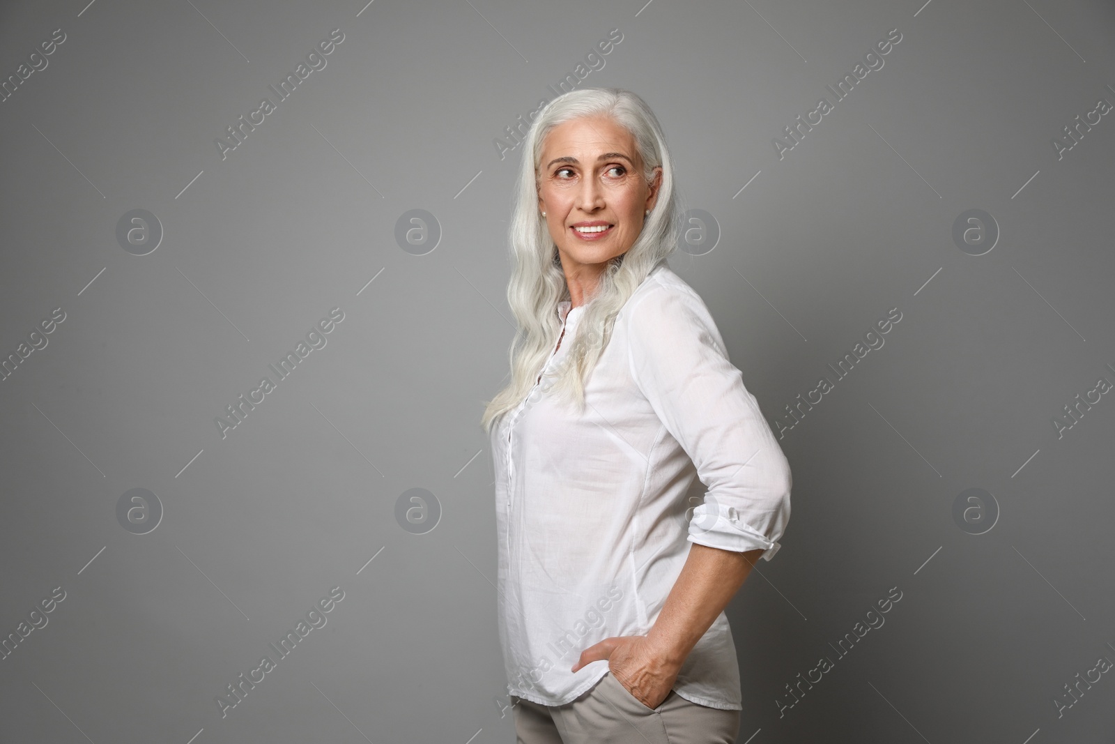 Photo of Portrait of beautiful mature woman on grey background