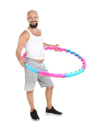 Overweight man with hula hoop on white background