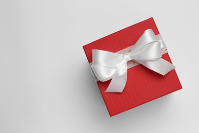 Photo of Gift box with bow on white background, top view