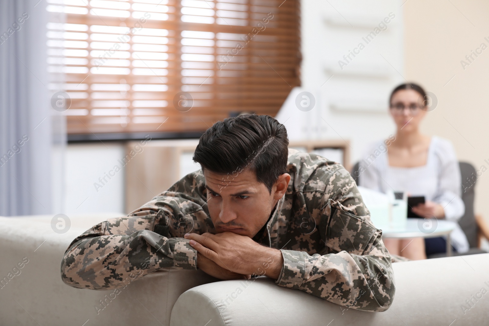 Photo of Male military officer having appointment with psychotherapist in office