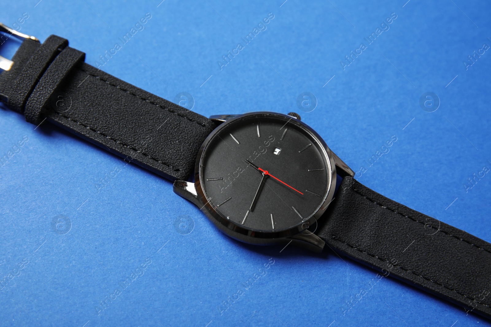 Photo of Stylish wrist watch on color background. Fashion accessory