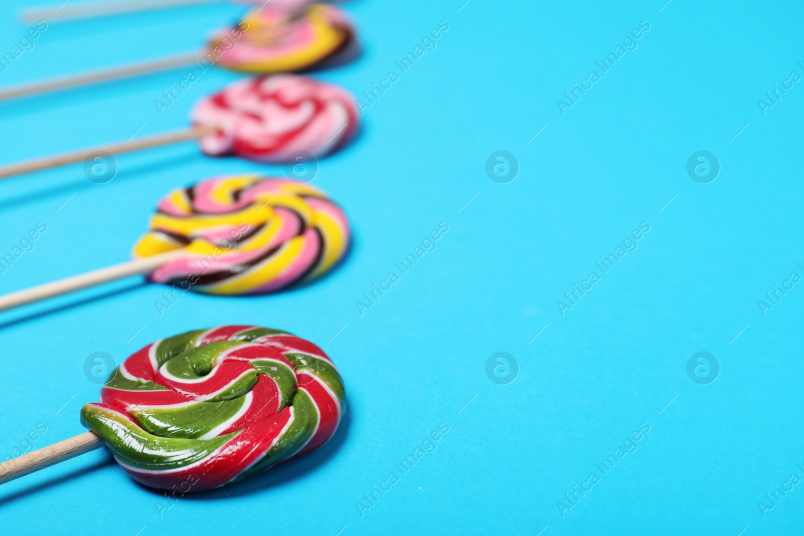 Photo of Bright yummy candies on color background. Space for text