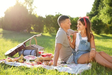 Photo of Happy couple having picnic in park on sunny day