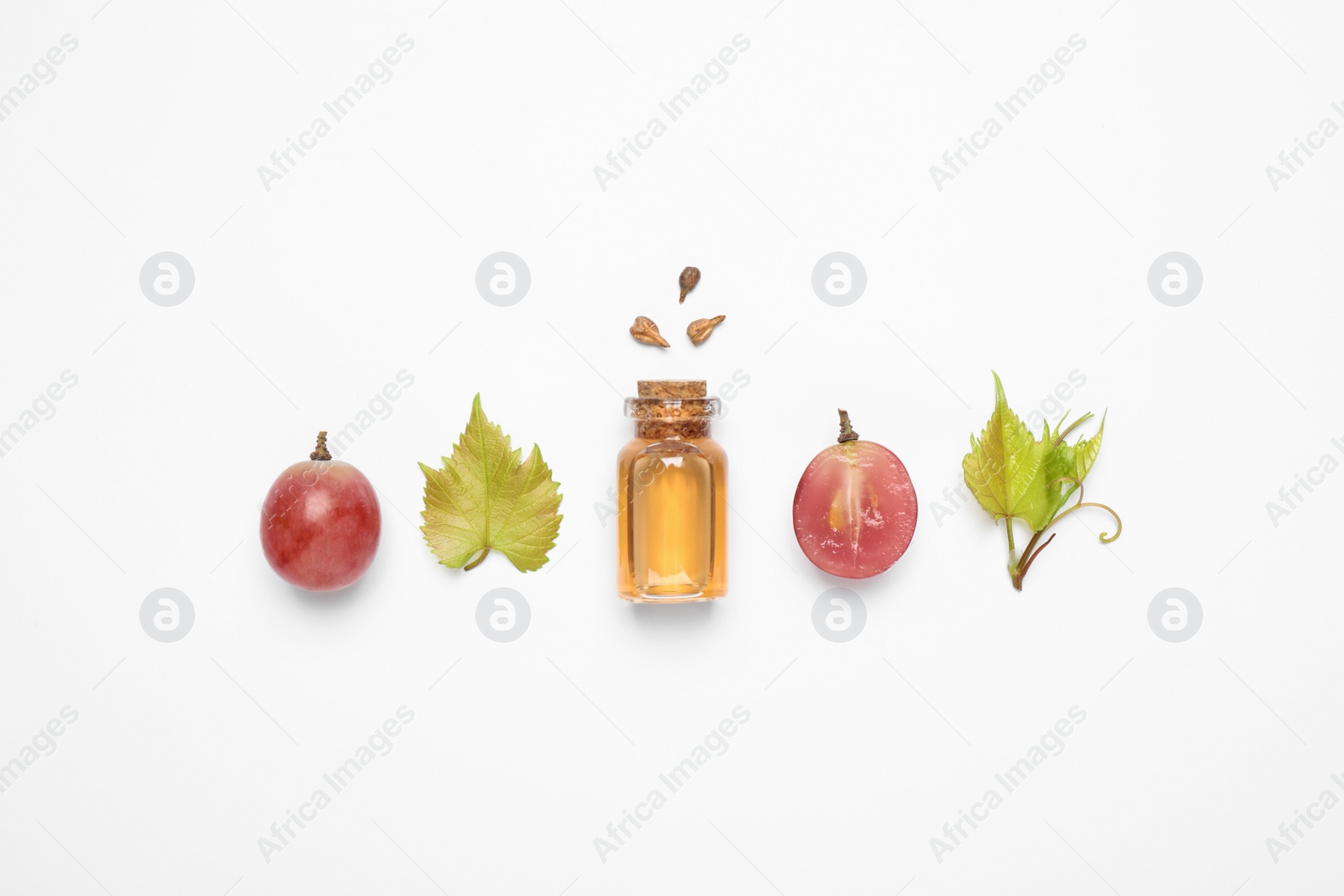 Photo of Composition with bottle of natural grape seed oil on white background, top view. Organic cosmetic