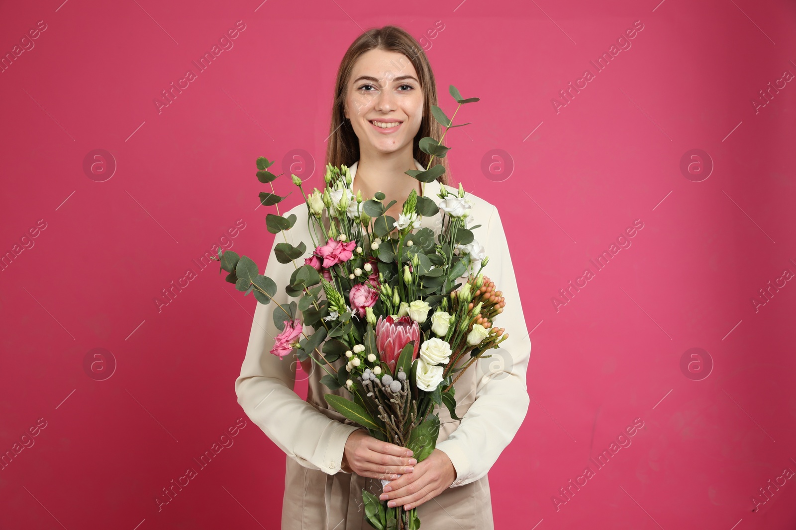 Photo of Florist with beautiful bouquet on pink background