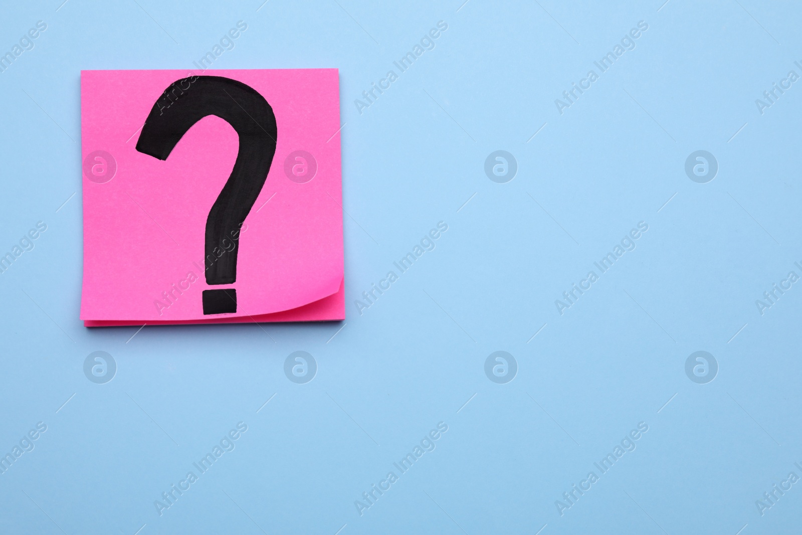 Photo of Sticky note with question mark on light blue background, top view. Space for text