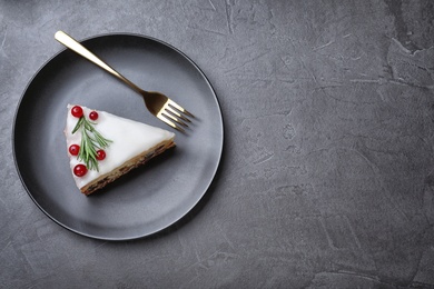 Slice of traditional Christmas cake served on black table, top view. Space for text