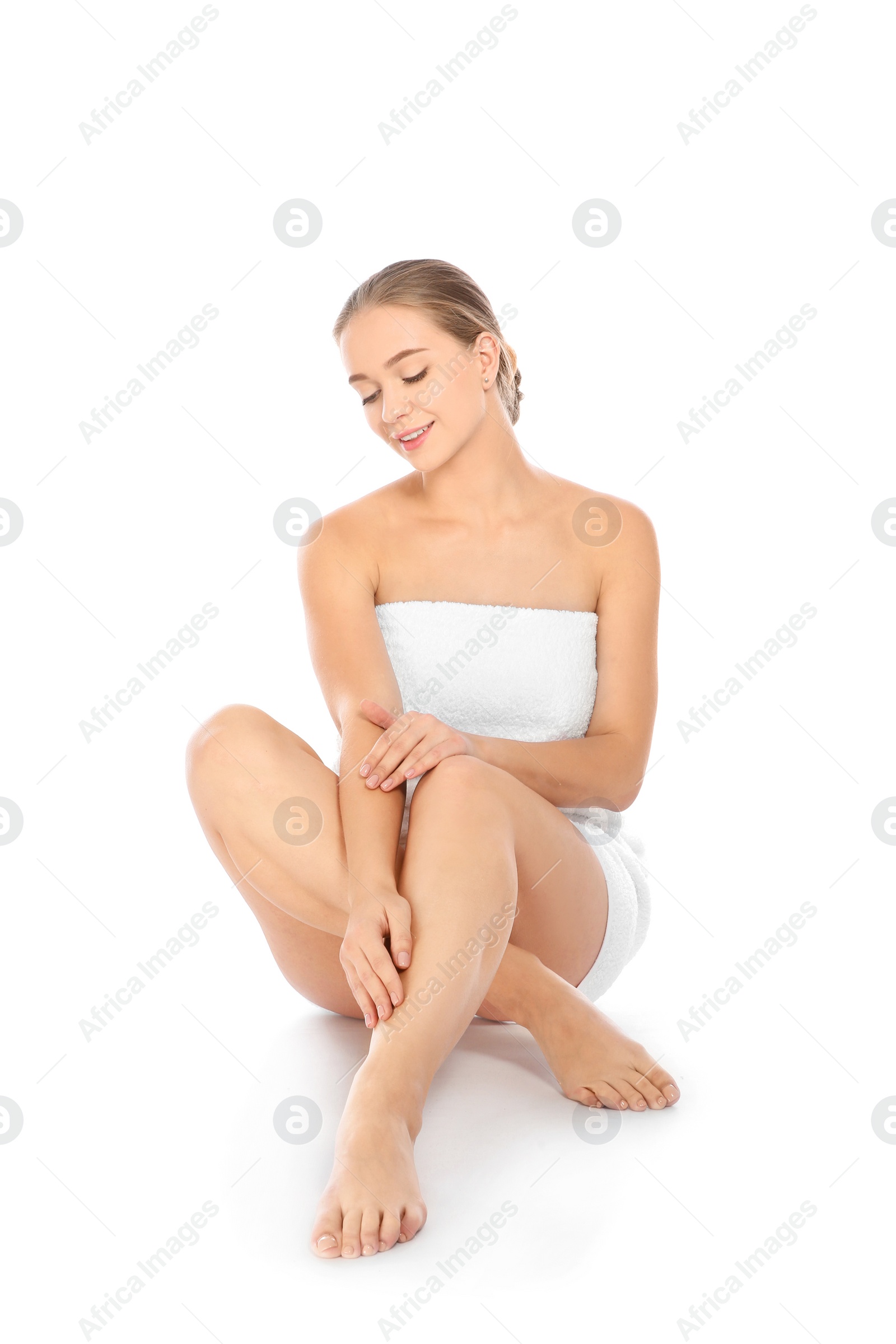 Photo of Portrait of young pretty woman with towel sitting on white background