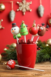 Delicious Christmas themed cake pops on wooden table