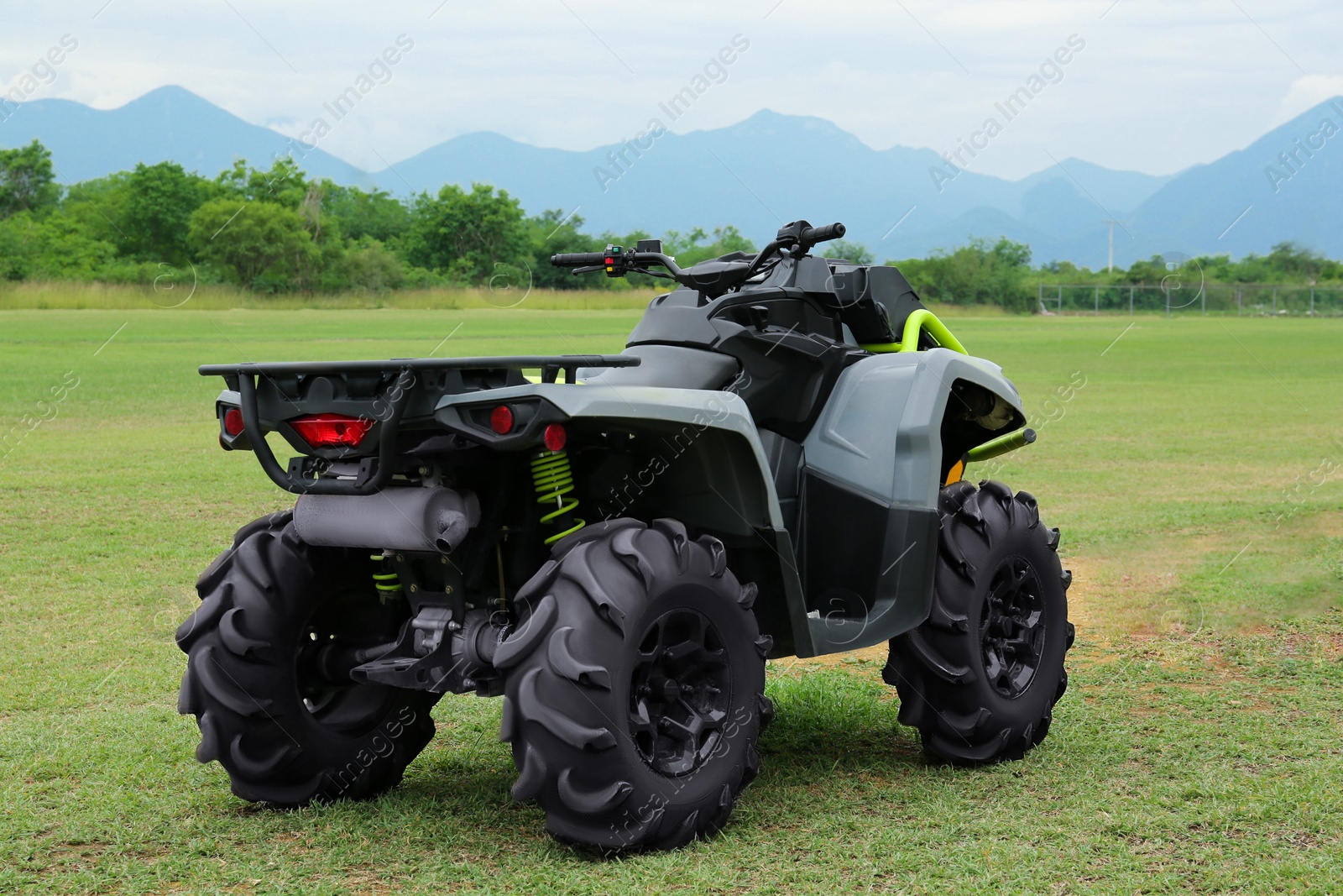 Photo of Modern quad bike on green grass outdoors