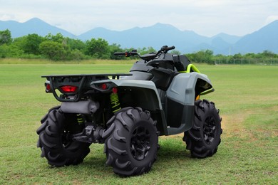 Photo of Modern quad bike on green grass outdoors