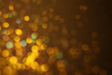 Photo of Blurred view of shiny lights on dark background. Bokeh effect