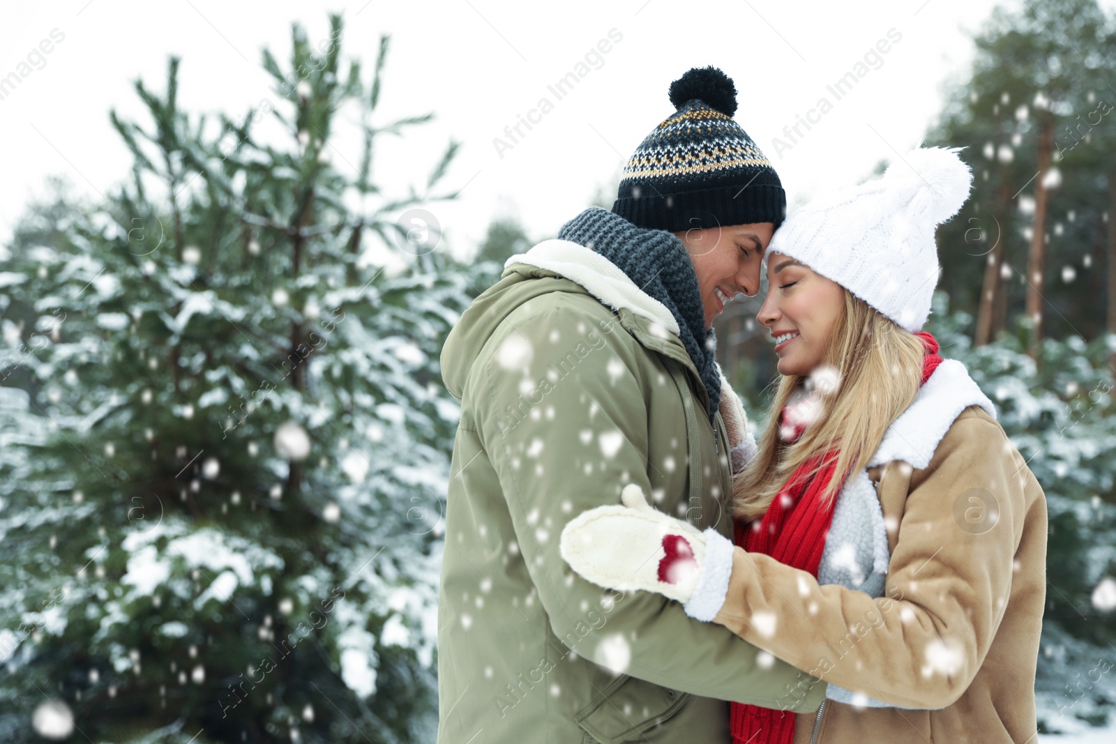 Photo of Beautiful happy couple in snowy forest on winter day