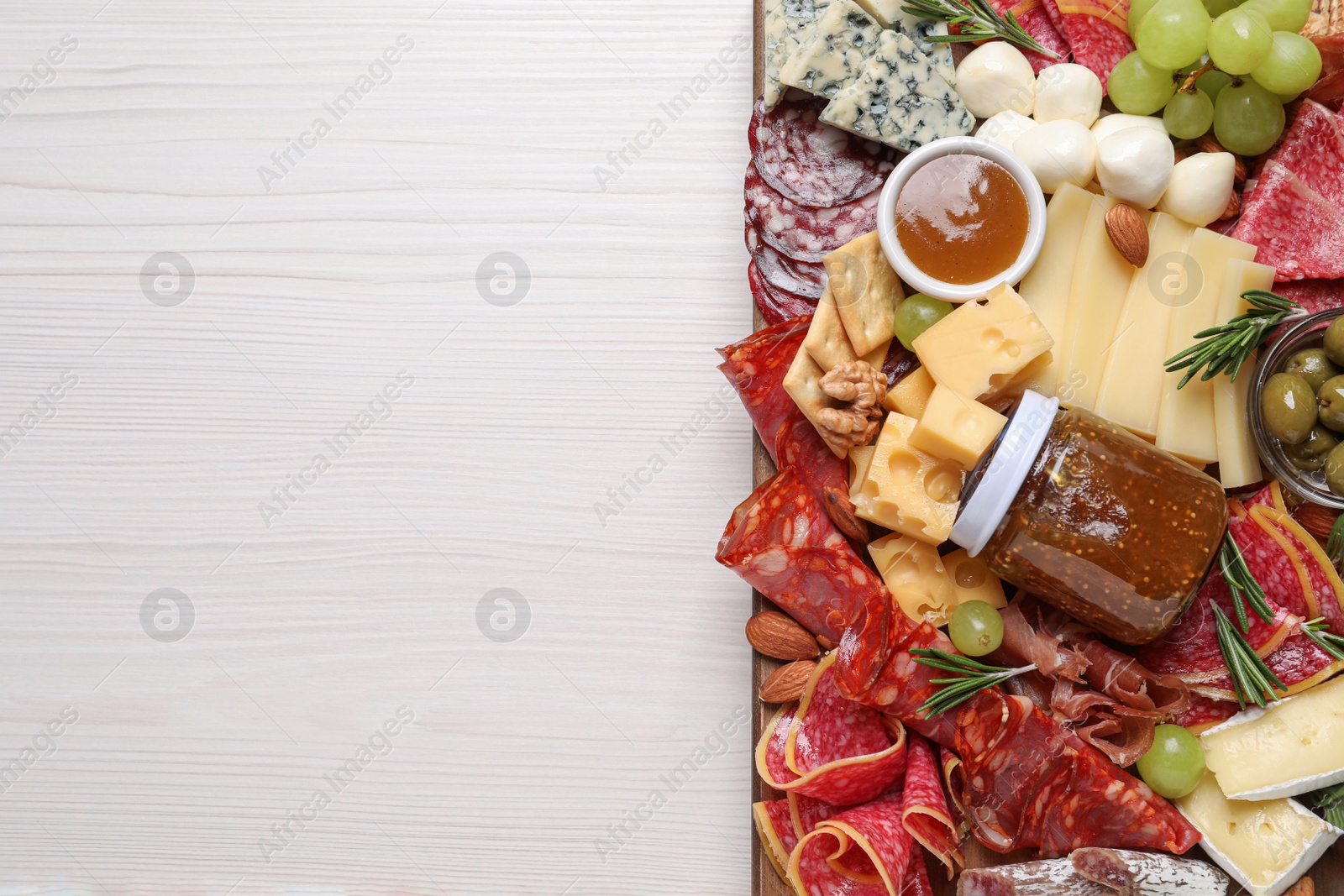 Photo of Assorted appetizer served on white wooden table, top view. Space for text