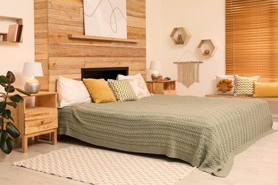 Photo of Stylish room interior with big comfortable bed