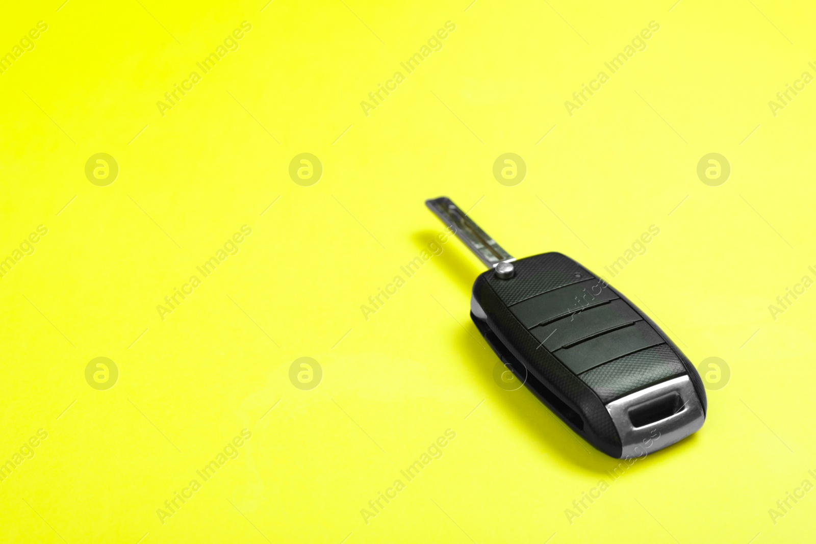 Photo of Car key on color background. Space for text