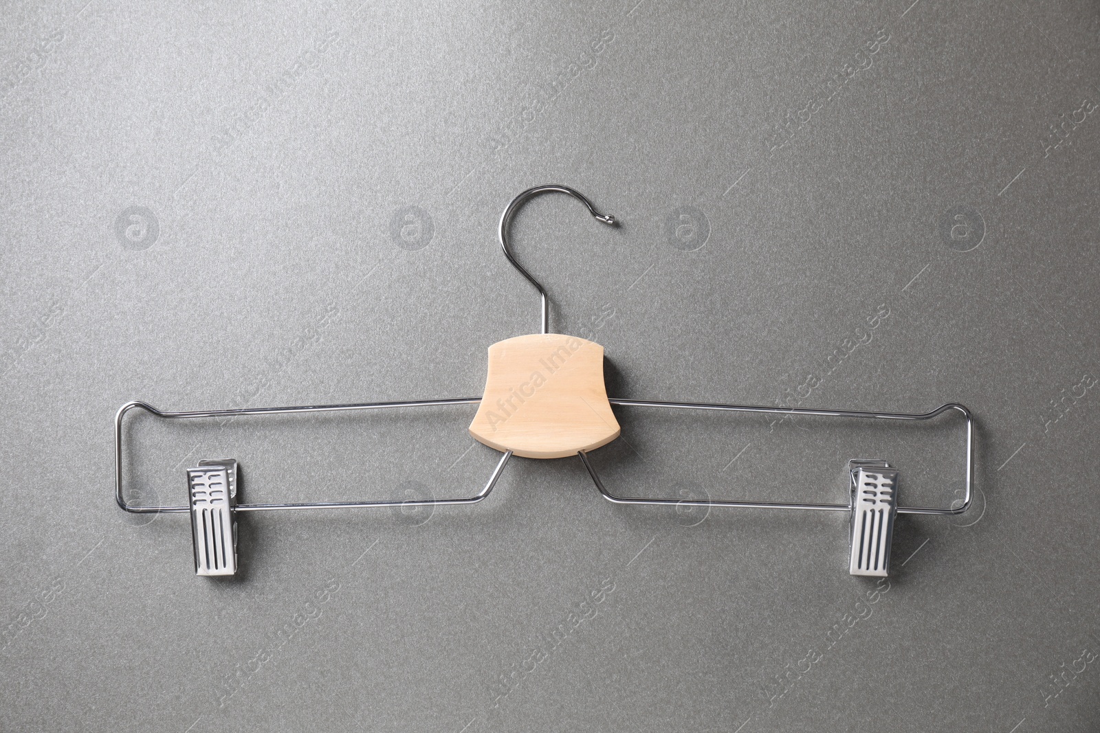 Photo of Hanger with clips on grey background, top view